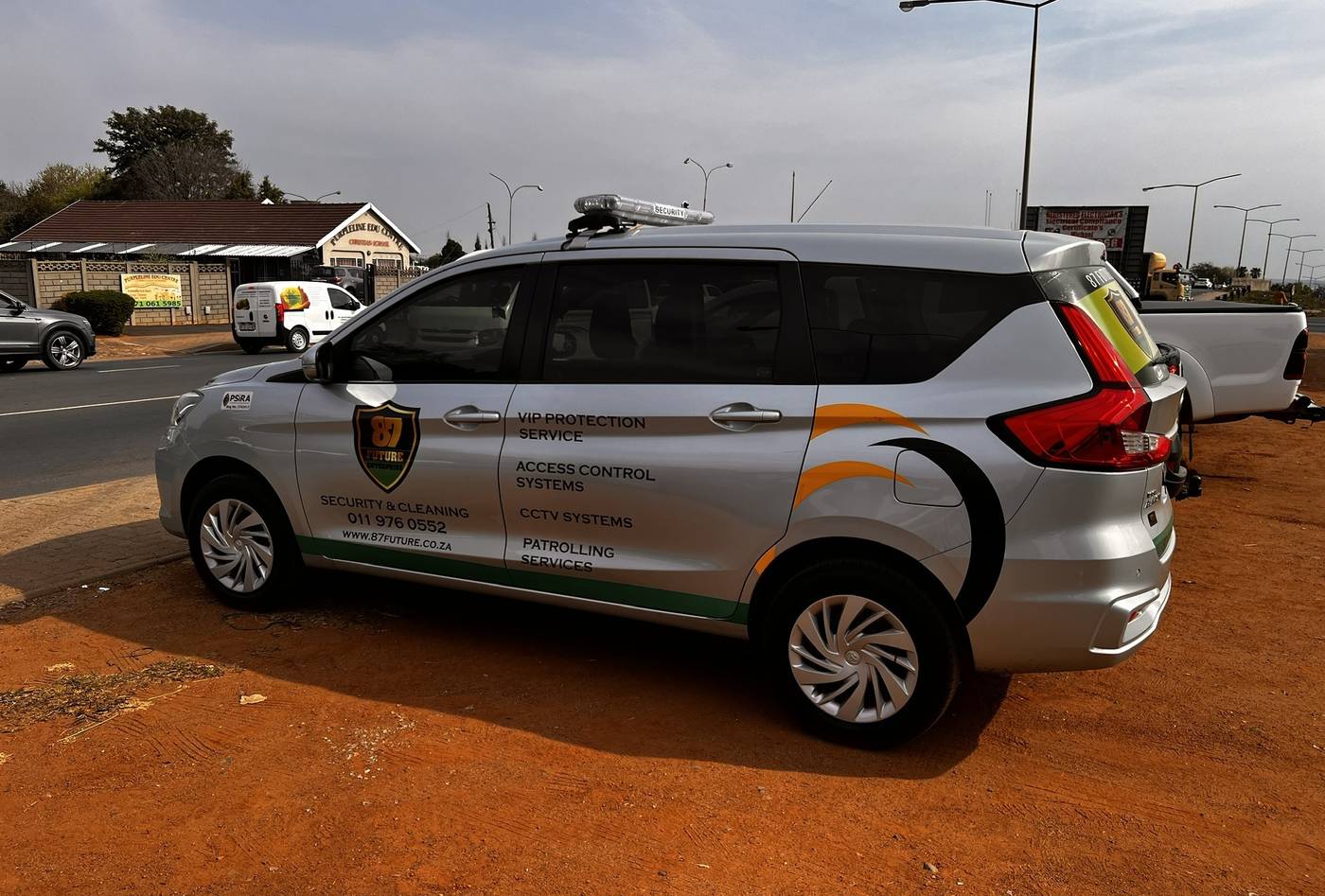 Silver multi-purpose vehicle in company livery