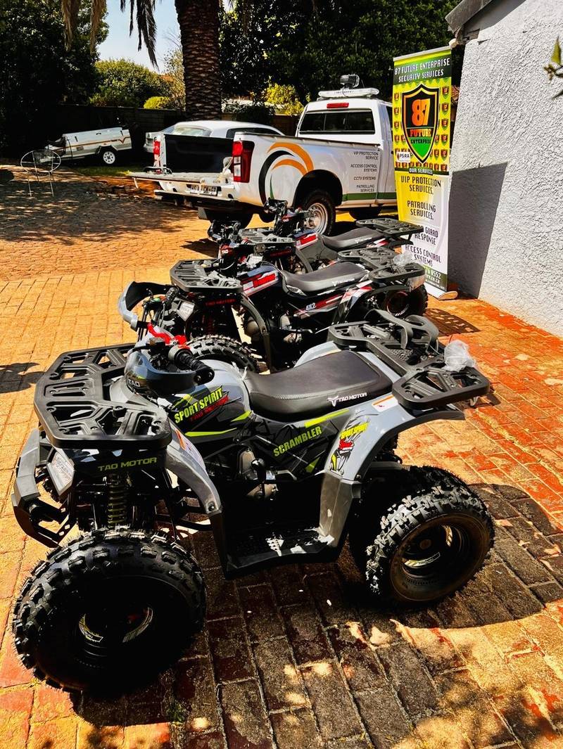 All-terrain quad bikes beside a patrol vehicle